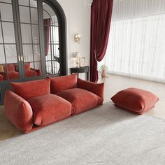 a red couch sitting in front of a mirror on top of a white carpeted floor