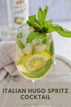 a glass filled with lemonade and mint garnish on top of a table