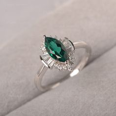 ◆ A marquise emerald ring clusters with baguette zircons, handcrafted with solid sterling sliver. A unique ring designed for multiple occasions. ◆ Production Description: Main stone Type: Lab Grown Emerald Main Stone Shape: Marquise Main Stone Size: 5*10mm Side stone: CZ Metal: 925 Sterling silver - Other options available in the drop down menu ◆ Customization: √Free for Add Engraving √Other Metal Type Available √Other Gemstones & Shapes Available √Personalization Requests Available ◆ Packag Marquise Diamond Emerald Ring For Gift, Marquise Emerald Ring With Diamond, Silver Marquise Emerald Ring For Anniversary, Marquise Emerald Ring For May Birthstone, Silver Marquise Emerald Ring, Marquise Emerald Ring For Anniversary, Silver Emerald Marquise Ring, Kays Engagement Ring, Ring Unique Design