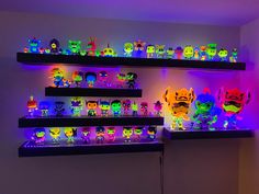 several shelves filled with different colored lights and cartoon figurines on top of them