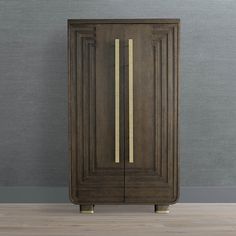 a tall wooden cabinet with gold trim on the bottom and sides, against a gray wall