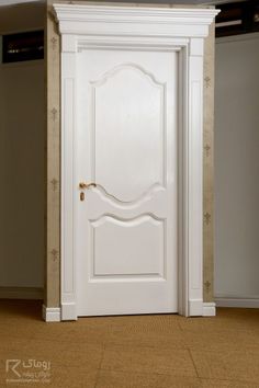 an open white door in the corner of a room with carpeted floor and walls