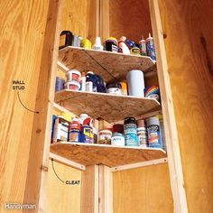 a wooden shelf filled with lots of different types of paint