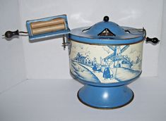 a blue and white container with a wooden handle