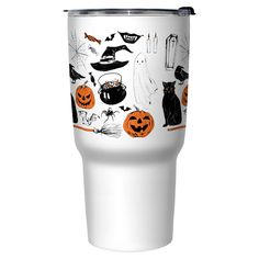 a white tumbler cup with black cats and pumpkins on it, sitting next to a