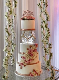 three tiered wedding cake with pink and white flowers