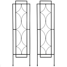 two tall black iron doors with decorative designs on the front and back sides, one is facing