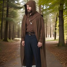 a man in a hooded cloak standing on a path