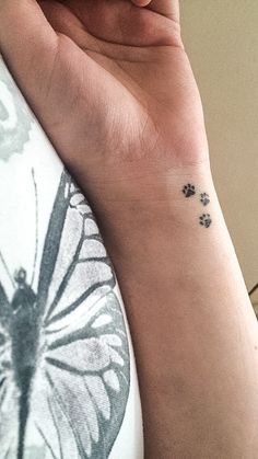 a person with a butterfly tattoo on their wrist