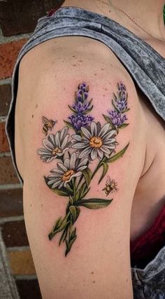 a woman's shoulder with flowers and butterflies on it