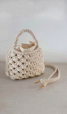 a white crocheted purse sitting on top of a table