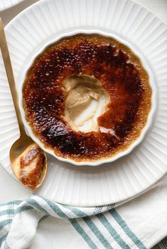 a white plate topped with sauce and a spoon