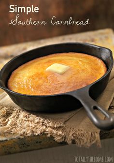 a close up of a skillet with food in it on a cloth next to a wooden table