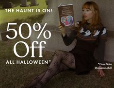 a woman sitting on the ground holding up a book with an ad for halloween sale