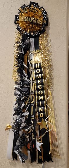 a black and gold party streamer hanging on the wall