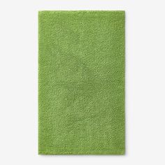 a bright green rug on a white background