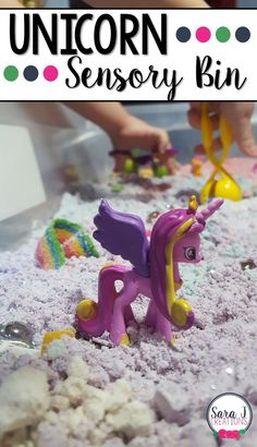 a close up of a toy pony in the sand with text overlay reading unicorn sensory bin