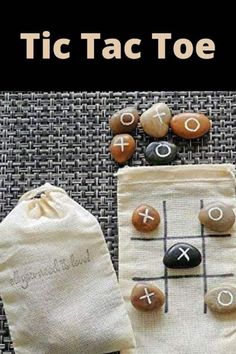 an image of tic tac toe game with rocks and drawstring bag