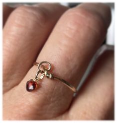 Love Me Knot. A beautiful 14 karat gold filled knot ring with a dangle heart charm. unique design and different thicknesses. The simple feature ring has a dangling garnet heart and is a statement ring that is super shiny and eye catching. Wear these beauty by itself or layered. Each ring set comes in a keepsake bag, suitable for gift-giving, or protecting your jewelry while traveling. Please feel free to contact me regarding customizing this bracelet or any of my other listings. I enjoy making c Gold Teardrop Jewelry For Promise, Delicate Hypoallergenic Promise Jewelry, Stackable Teardrop Jewelry For Gifts, 14k Gold Teardrop Jewelry For Promise, Spiritual 14k Gold Stackable Rings As Gift, Delicate Teardrop Ring For Gifts, Hand Wrapped Toe Ring Jewelry For Gifts, Adjustable Recycled Gold Jewelry For Promise, Hand-wrapped Yellow Gold Jewelry Gift