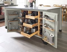 an open cabinet in the middle of a kitchen