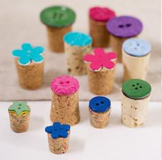 there are many small corks with flowers on them and buttons in the top one