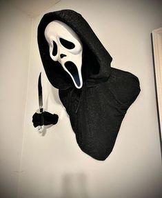 a mask and knife are hanging on the wall