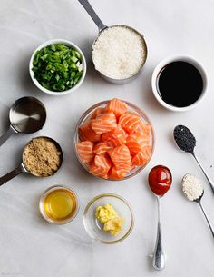 the ingredients are laid out on the table to be prepared for this meal, including salmon and rice