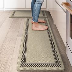 a woman is standing on the kitchen floor with her feet in the oven door mat