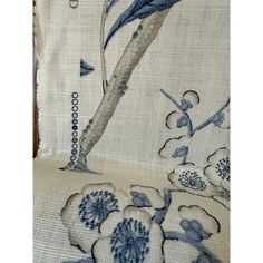 an upholstered chair with blue and white flowers on it