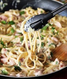 a skillet filled with pasta and ham