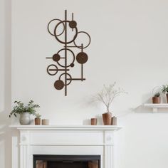 a living room filled with furniture and a fire place in front of a white wall