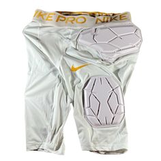 the nike pro knee pads are white with gold lettering on them and an orange stripe