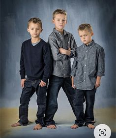 three young boys are posing for a portrait