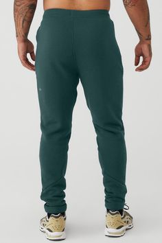 Layer it to and from the studio, practice in it or lounge in it: the Triumph Sweatpant is made of insanely comfortable triblend fleece. An easy-fitting drop crotch, wide gusset panel and drawcord waist are finished with fitted rib panels on the calves and inseam. For working out and wearing out Adjustable drawcord waistband Invisible zip pockets Alo Yoga Sports Bottoms With Elastic Waistband, Alo Yoga Athleisure Loungewear Bottoms, Alo Yoga Athleisure Bottoms For Loungewear, Alo Yoga Cotton Activewear For Loungewear, Alo Yoga Full Length Loungewear Pants, Alo Yoga Full-length Loungewear Pants, Sporty Alo Yoga Bottoms With Comfort Waistband, Alo Yoga Sporty Bottoms With Comfort Waistband, Alo Yoga Cotton Activewear For Sports