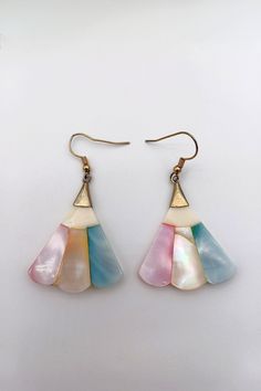 Vintage 1970s Pastel Tricolor Shell Dangle Earrings  This listing is of a set of vintage pastel tricolor shell and dangle earrings in soft pink, turquoise, and cream. The wire and metal are gold-toned. These 1970s shell earrings are in excellent used-vintage condition, although there are some signs of wear, especially in the metal parts (see photos). The shell pieces are layered on top of cream-colored plastic. Dimensions:  The earrings are about 2" in length by 1.25" in width. Retro Multicolor Drop Earrings, Vintage Multicolor Ear Wire Earrings, Vintage Pink Drop Earrings, Vintage Pink Dangle Earrings, Retro Pink Drop Earrings, Rose Pale, Laser Cut Acrylic, Shell Earrings, Etsy Earrings Dangle