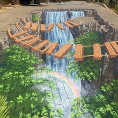 an artistic mural on the side of a building shows a waterfall and wooden benches in front of it