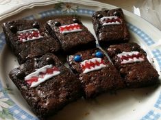 brownies decorated with red, white and blue icing on a plate