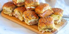 ham and cheese sliders on a cutting board