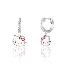 Elevate your accessories game with our Hello Kitty Charm Hoop Earrings, a delightful blend of playful charm and elegant style. These earrings feature classic hoop design embellished with a dangling Hello Kitty charm, capturing the beloved icon's spirit in every sway. Crafted with meticulous attention to detail, the charming Hello Kitty pendant is a symbol of joy and nostalgia. These earrings add a touch of whimsy to your ensemble while maintaining a sophisticated edge. Whether you're reliving yo Hello Kitty Charm, Hoop Charms, Hoop Design, Cat Pendants, Silver Enamel, Charm Earrings, Elegant Style, Cubic Zirconia, Hello Kitty