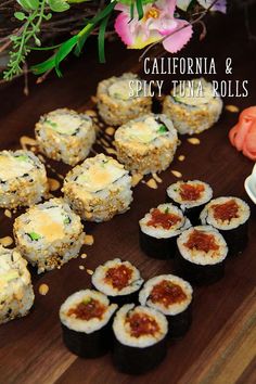 sushi rolls on a wooden table with flowers in the background and text overlay that reads california & spicy tuna rolls