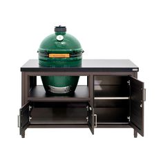 the big green egg is sitting on top of an entertainment center