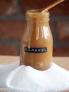 a jar filled with liquid sitting on top of a pile of sugar