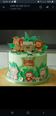 a green cake with animals and cars on it