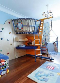 a child's bedroom with a bunk bed, desk and hanging hammock