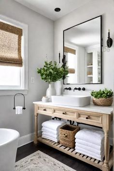 a bathroom with a sink, mirror and towels on the shelf in front of it