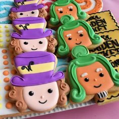 decorated cookies are arranged in the shape of children's faces