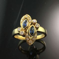 14K Yellow Gold Sapphire and Diamond Ring METAL: 14K Yellow Gold               TOTAL WEIGHT: 4.2 g (approximate, varies per size) DIAMONDS: Round Brilliant Cut Diamonds                        COLOR:  G/H                        CLARITY: VS2                        TOTAL WEIGHT: 0.20 ct GEMSTONES: Marquise Cut Natural Sapphires                          TOTAL WEIGHT: 0.30 ct SIZE: Ladies Size 4-8. Please indicate your ring size at checkout. DESCRIPTION: Beautiful yellow gold ring featuring two marqu Marquise Sapphire, Moonstone Engagement, Sapphire And Diamond Ring, Moonstone Engagement Ring, Ring With Diamond, Rainbow Moonstone Ring, Ring Metal, Moonstone Ring, Natural Sapphire