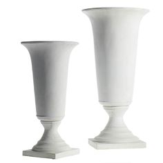 two white vases sitting next to each other