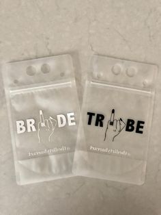 two plastic bags with the words bride and groom written in black on them, sitting next to each other