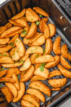 some fried food is being cooked in an oven with green garnish on top